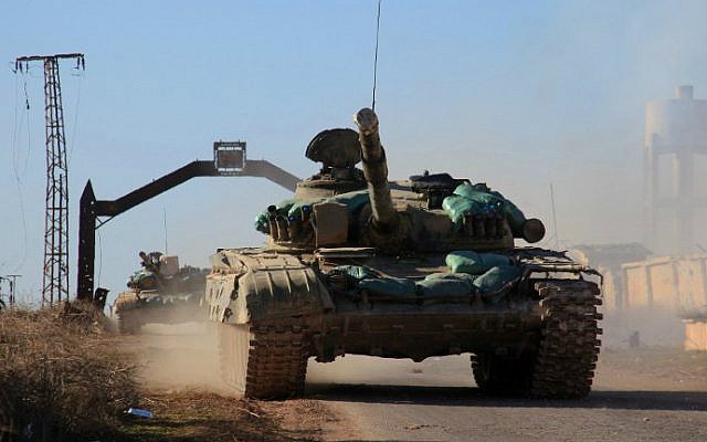 Syrian government tanks drive in the village of Tal Jabin, north of the embattled city of Aleppo, as they advanced to break a three-year rebel siege of two government-held Shiite villages, Nubol and Zahraa, and take control of parts of the supply route to the area on February 3, 2016. (George Ourfalian/AFP) Syrian government tanks drive in the village of Tal Jabin, north of the embattled city of Aleppo, as they advanced to break a three-year rebel siege of two government-held Shiite villages, Nubol and Zahraa, and take control of parts of the supply route to the area on February 3, 2016. (George Ourfalian/AFP)