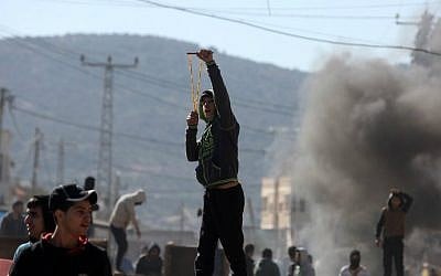 Palestinian youths clash with Israeli security forces in Qabatiya, a town near Jenin in the northern West Bank, on February 4, 2016. (Jaafar Ashtiyeh/AFP)