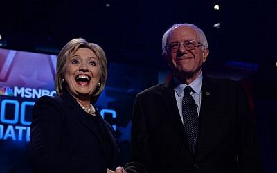 US Democratic presidential candidates Hillary Clinton and Bernie Sanders shake hands before participating in a debate at the University of New Hampshire in Durham, February 4, 2016. (AFP/Jewel Samad)