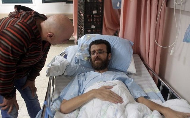 Mohammed al-Qiq, a Palestinian prisoner who carried out hunger strike, talks to a man in a hospital in the northern Israeli town of Afula on February 5, 2016. (Ahmad Gharabli/AFP) Mohammed al-Qiq, a Palestinian prisoner who carried out hunger strike, talks to a man in a hospital in the northern Israeli town of Afula on February 5, 2016. (Ahmad Gharabli/AFP)