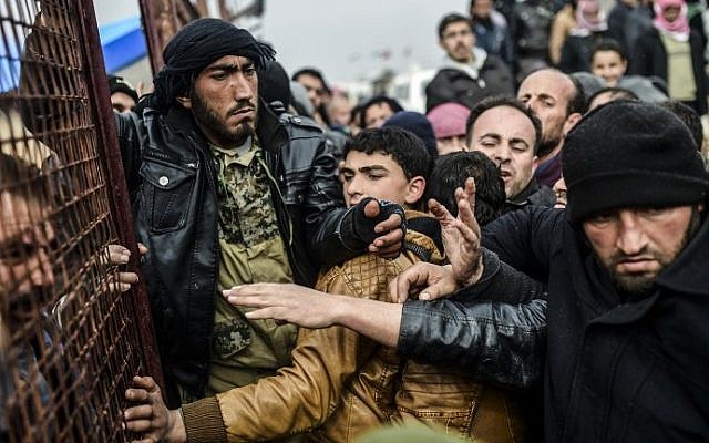 Refugees push each other as they wait for tents as Syrians fleeing the northern embattled city of Aleppo wait on February 6, 2016 in Bab al-Salama, near the city of Azaz, northern Syria, near the Turkish border crossing. (Bulent Kilic/AFP)