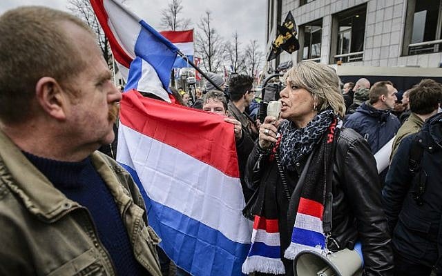 Demonstrators wave national flags of the Netherlands as members of Pegida (Patriotic Europeans Against the Islamization of the Occident) protest in central Amsterdam on February 6, 2016. (Remko De Waal/ANP/AFP)