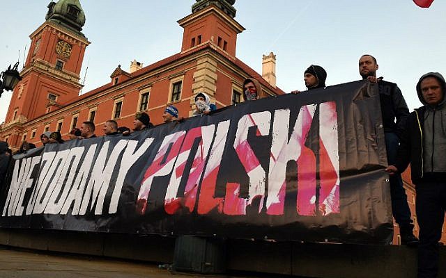 Supporters of the Pegida (Patriotic Europeans Against the Islamization of the Occident) movement demonstrate in front of the royal castle in Warsaw, Poland with a banner reading, "We will not give back Poland," February 6, 2016. (Janek Skarzynski/AFP)