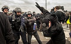 Policemen arrest a supporter of the Pegida (Patriotic Europeans Against the Islamization of the Occident) movement during a demonstration in Calais, northern France on February 6, 2016. (Philippe Huguen/AFP)