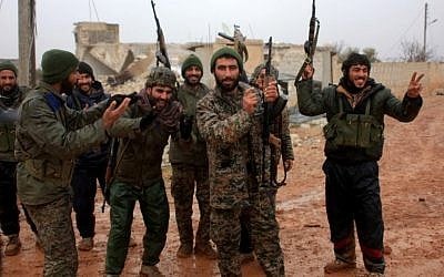 Syrian government soldiers celebrate after taking control of the village of Ratian, north of the embattled city of Aleppo, from rebel fighters on February 6, 2016. (AFP / GEORGE OURFALIAN)