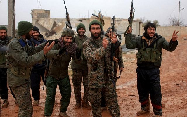 Syrian government soldiers celebrate after taking control of the village of Ratian, north of the embattled city of Aleppo, from rebel fighters on February 6, 2016. (AFP / GEORGE OURFALIAN)