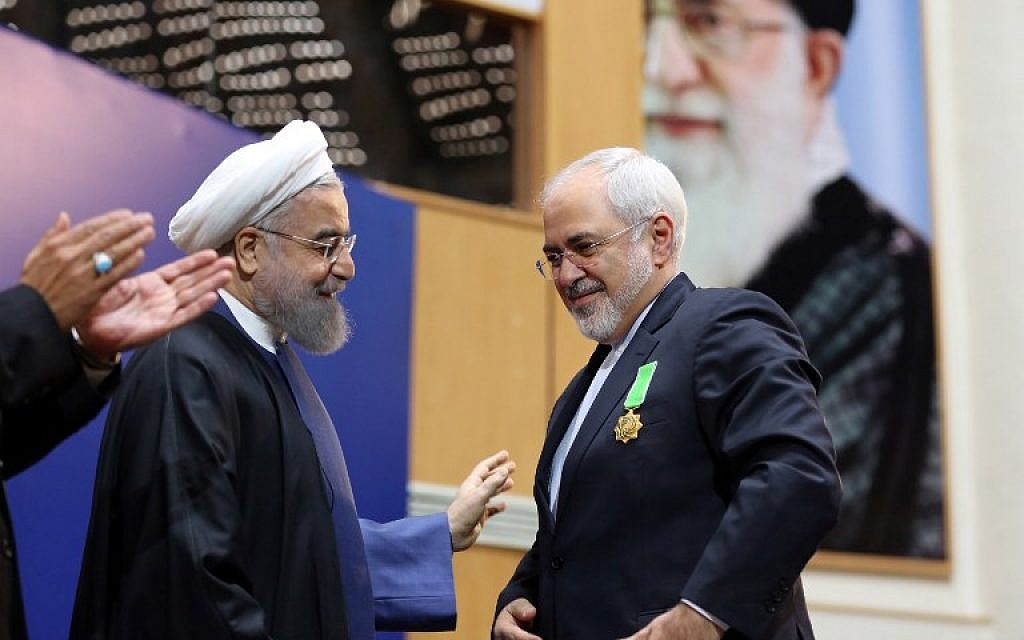 File: Iranian President Hassan Rouhani, left, awards Foreign Minister Mohammad Javad Zarif with the Medal of Honor for his role in the implementation of a nuclear deal with world powers, on February 8, 2016, in Tehran. (AFP / ATTA KENARE)