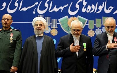 Iran's Defense Minister Hossein Dehghan (L), Foreign Minister Mohammad Javad Zarif (2nd from R) and Ali Akbar Salehi (R), the head of Iran's Atomic Energy Organization, pose for pictures after receiving the Medal of Honor from President Hassan Rouhani (2nd from L) for their role in the implementation of a nuclear deal with world powers, on February 8, 2016, in Tehran. (Atta Kenare/AFP)