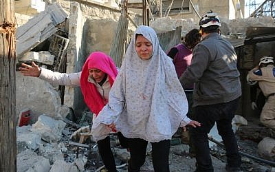 Syrian girls react following a reported Syrian regime air strike in a rebel-controlled area in the northern city of Aleppo on February 8, 2016. AFP / Ameer al-Halbi)