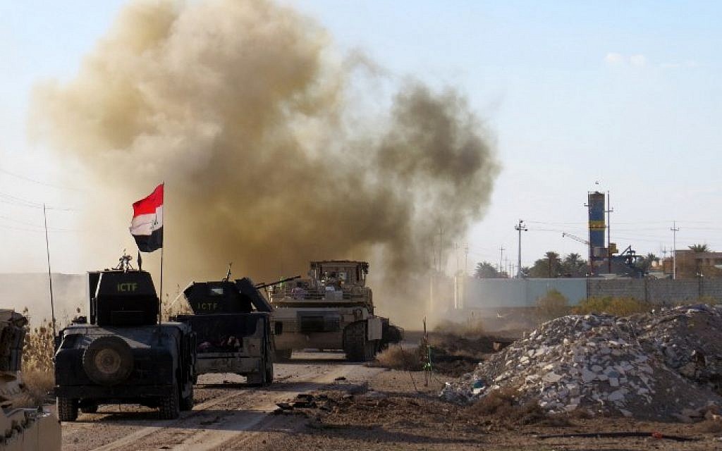 Iraqi pro-governement forces drive their armoured vehicles in the Jwaibah area, on the eastern outskirts of Ramadi, on February 8, 2016, after they retook the region from Islamic State (IS) group jihadists (AFP/MOADH AL-DULAIMI)