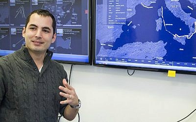 Israeli Ami Daniel, CEO and co-founder of the Windward company speaks in front of a screen as he poses at the company's offices on February 9, 2016 in the Israeli city of Tel Aviv. (Jack Guez/AFP)