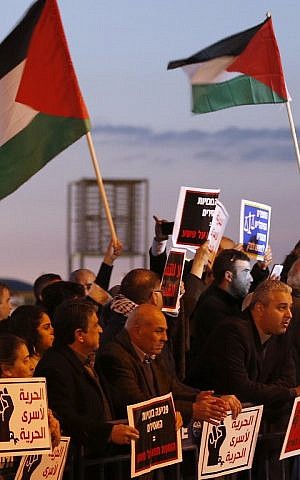 Arab Israelis take part in a protest calling for the release of Mohammed al-Qiq, a Palestinian prisoner on hunger strike, outside a hospital in the northern town of Afula on February 9, 2016. (AFP/AHMAD GHARABLI)