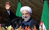 Iranian President Hassan Rouhani waves to the crowd during a rally in Tehran's Azadi Square (Freedom Square) to mark the 37th anniversary of the Islamic revolution on February 11, 2016. (Atta Kenare/AFP)