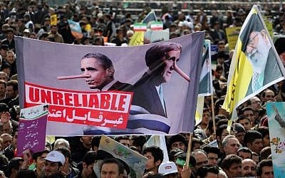 Iranians hold an anti-US slogan during celebrations in Tehran's Azadi Square (Freedom Square) to mark the 37th anniversary of the Islamic revolution on February 11, 2016. Posters depict President Obama and Secretary Kerry with Pinocchio-style liars' noses, and the text 'Unreliable' (Atta Kenare/AFP)