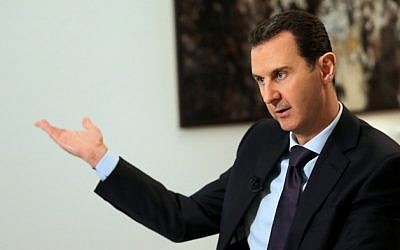 Syrian President Bashar Assad gestures during an interview in the capital Damascus on February 11, 2016. (AFP/Joseph Eid)