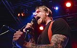 Eagles of Death Metal singer Jesse Hughes performs on the stage of the Debaser Medis in Stockholm, on February 13, 2016. (Vilhelm Stokstad/TT News Agency/AFP)