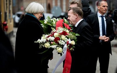 Danish Prime Minister Lars Lokke Rasmussen (R) and Mayor of Copenhagen Frank Jensen (hidden) are speaking to Bodil Uzan (L), the mother of Dan Uzan who was killed while working as a security guard at the synagoge, during a commemoration in Copenhagen February 14, 2016. (AFP / Scanpix / Liselotte SABROE / Denmark OUT)