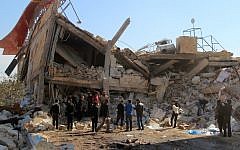 File: People gather around the rubble of a hospital supported by Doctors Without Borders (MSF) near Maaret al-Numan, in Syria's northern province of Idlib, on February 15, 2016, after the building was hit by suspected Russian air strikes. (Ghaith Omran/Al Maarra Today/AFP)