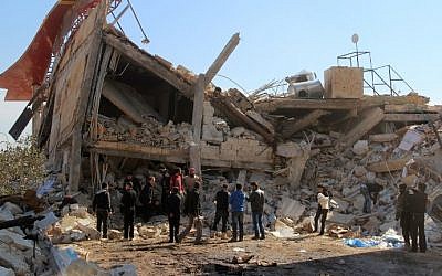 File: People gather around the rubble of a hospital supported by Doctors Without Borders (MSF) near Maaret al-Numan, in Syria's northern province of Idlib, on February 15, 2016, after the building was hit by suspected Russian air strikes. (Ghaith Omran/Al Maarra Today/AFP)