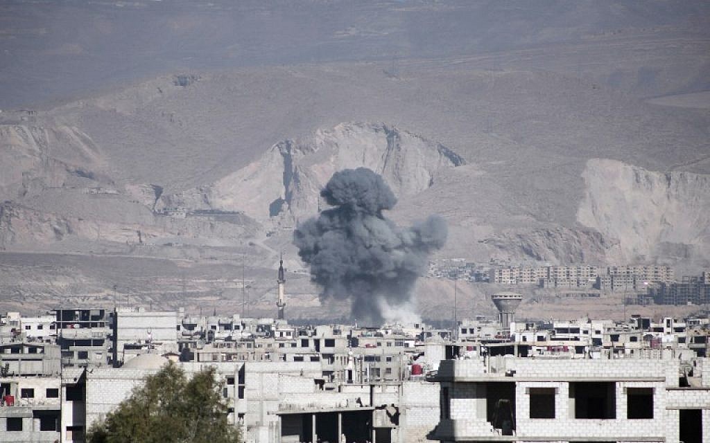 Illustrative: Smoke billows following reported air strikes by Syrian government forces on the town of Arbin in the eastern Ghouta region on February 17, 2016. (AFP / AMER ALMOHIBANY)