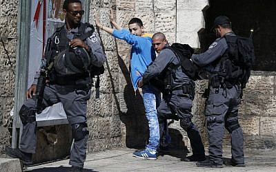 Illustrative. Border police check a Palestinian at Damascus Gate in the Old City of Jerusalem on February 17, 2016. (AFP / AHMAD GHARABLI)