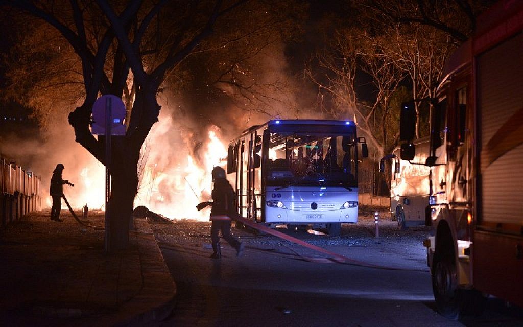 Firefighters try to extinguish flames following an explosion after an attack targeted a convoy of military service vehicles in Ankara on February 17, 2016. (AFP / STRINGER)