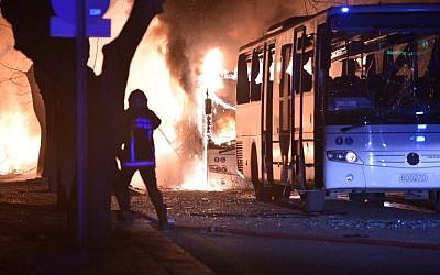 Firefighters try to extinguish flames following an explosion after an attack targeted a convoy of military service vehicles in Ankara on February 17, 2016.  (AFP / STRINGER)