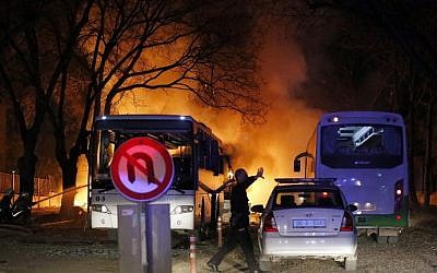 A police officer gestures as he walks at the site of an explosion while firefighters try to extinguish flames after an attack targeted a convoy of military service vehicles in Ankara on February 17, 2016. (AFP / CIHAN NEWS AGENCY / STRINGER) A police officer gestures as he walks at the site of an explosion while firefighters try to extinguish flames after an attack targeted a convoy of military service vehicles in Ankara on February 17, 2016. (AFP / CIHAN NEWS AGENCY / STRINGER)