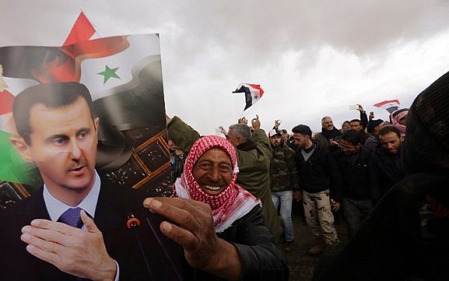 Syrian volunteers and their relatives wave the national flag and portraits of President Bashar Assad as they celebrate at the end of a paramilitary training conducted by the Syrian army on February 22, 2016. (AFP / LOUAI BESHARA) Syrian volunteers and their relatives wave the national flag and portraits of President Bashar Assad as they celebrate at the end of a paramilitary training conducted by the Syrian army on February 22, 2016. (AFP / LOUAI BESHARA)