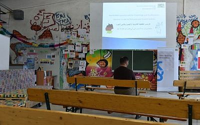 A Syrian refugee wait for the start of the rights education lessons for refugees and asylum seekers in a hall of the "Bayernkaserne" in Munich, southern Germany on February 24, 2016. (Christof Stache/AFP)