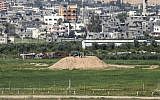 A picture taken from the Israeli side of the border with the Gaza Strip shows a Palestinian man and children on top of a Hamas outpost along the border, on February 25, 2016. (Jack Guez/AFP)