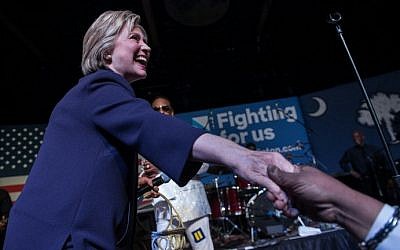 US Democratic presidential candidate Hillary Clinton shakes hands after making an appearance on stage at the Music Farm in Charleston, South Carolina, on February 25, 2016 during a concert by singer Charlie Wilson. (AFP / Nicholas Kamm)