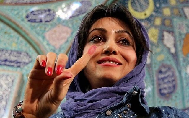 An Iranian woman displays her ink-stained finger after casting her ballot for both parliamentary elections and the Assembly of Experts at a polling station in Tehran on February 26, 2016. (AFP / ATTA KENARE) An Iranian woman displays her ink-stained finger after casting her ballot for both parliamentary elections and the Assembly of Experts at a polling station in Tehran on February 26, 2016. (AFP / ATTA KENARE)