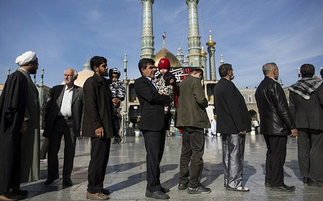 Iranians line up outside a polling station at Massoumeh shrine during the parliamentary and Assembly of Experts elections at a polling station in the holy city of Qom, February 26, 2016. (AFP/Behrouz Mehri) Iranians line up outside a polling station at Massoumeh shrine during the parliamentary and Assembly of Experts elections at a polling station in the holy city of Qom, February 26, 2016. (AFP/Behrouz Mehri)