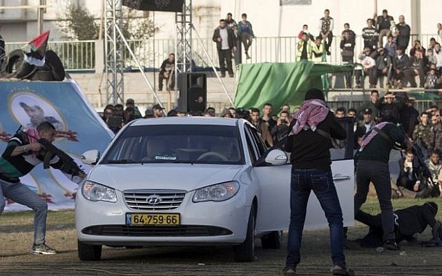 Palestinian boys simulate an attack on an Israeli car during a show as part of an anti-Israel rally on February 26, 2016, in the southern Gaza Strip town of Rafah. (AFP/SAID KHATIB)