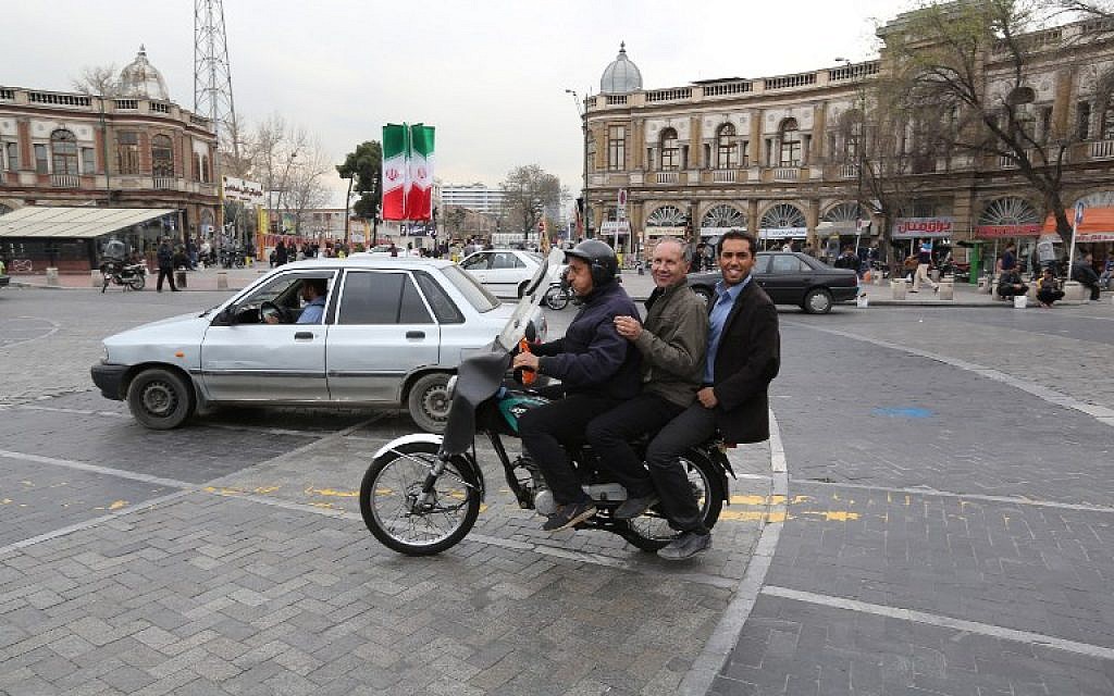 Iranian men take a ride on a motorcycle taxi at Hafez square in central in Tehran on February 29, 2016. (AFP / ATTA KENARE)