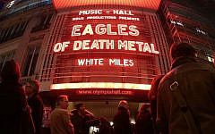 People standing outside the Olympia concert venue in Paris, a few hours ahead of a concert by US rock group Eagles of Death Metal, on February 16, 2016 (AFP PHOTO / JOEL SAGET)
