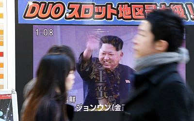 File: Pedestrians walk past a TV on a street in Tokyo showing North Korea's leader Kim Jong Un and a report on North Korea's rocket launch on February 7, 2016. (AFP Photo/Yoshikazu Tsuno)