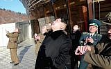 This picture taken from North Korean TV and released by South Korean news agency Yonhap on February 7, 2016, shows North Korean leader Kim Jong Un (center), looking at the locket launch of the satellite Kwangmyong 4. (AFP/North Korean TV via Yonhap)