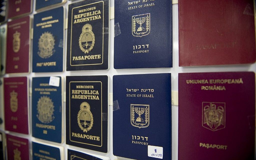 Fake passports are displayed at the immigration bureau in Bangkok on February 10, 2016, after Thai police broke up a major fake passport ring led by an Iranian known as 'The Doctor' which sent thousands of passports to Middle Eastern customers trying to enter Europe. (AFP PHOTO / NICOLAS ASFOURI)