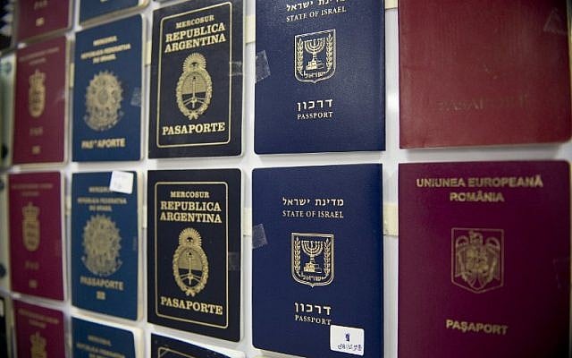 Fake passports are displayed at the immigration bureau in Bangkok on February 10, 2016 after Thai police broke up a major fake passport ring led by an Iranian known as "The Doctor" which sent thousands of passports to Middle Eastern customers trying to enter Europe. (AFP PHOTO / NICOLAS ASFOURI)