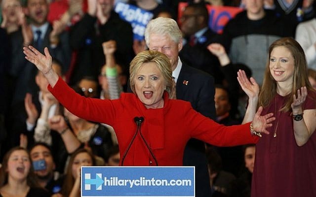 Democratic presidential candidate former Secretary of State Hillary Clinton speaks to supporters as Former US president Bill Clinton and daughter Chelsea Clinton look on during her caucus night event in the Olmsted Center at Drake University on February 1, 2016 in Des Moines, Iowa. (Win McNamee/Getty Images/AFP)