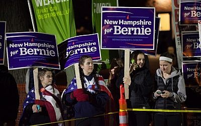 Supporters of Democratic presidential candidate U.S. Sen. Bernie Sanders (I-VT) hold signs near the site of the Democratic debate on February 4, 2016 in Durham, New Hampshire. (Matthew Cavanaugh/Getty Images/AFP)
