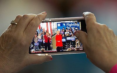 A supporter takes a photo of Democratic Presidential candidate and former Secretary of State Hillary Clinton at a campaign rally at Truckee Meadows Community College in Reno, Nevada, February 15, 2016. (David Calvert/Getty Images/AFP)