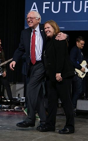 Democratic presidential candidate Sen. Bernie Sanders (I-VT) and his wife, Jane O'Meara Sanders, walk off the stage together during a rally in Henderson, Nevada on February 19, 2016. (Joe Raedle/Getty Images/AFP)