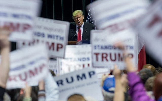 People wave signs as Republican presidential candidate Donald Trump speaks during a campaign rally at the Georgia World Congress Center, Sunday, February 21, 2016 in Atlanta, Georgia. (Branden Camp/Getty Images/AFP) People wave signs as Republican presidential candidate Donald Trump speaks during a campaign rally at the Georgia World Congress Center, Sunday, February 21, 2016 in Atlanta, Georgia. (Branden Camp/Getty Images/AFP)
