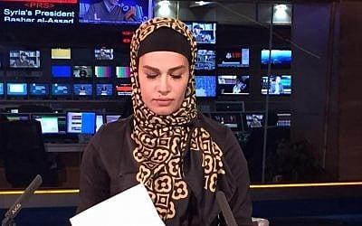 Photo shows Sheena Shirani sitting at the news desk at Press TV.  (Facebook)