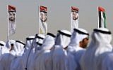 Emirati men perform a traditional dance in front of flags bearing portraits of Abu Dhabi's Crown Prince Sheikh Mohammed bin Zayed al-Nahyan, February 9, 2016. (AFP/Karim Sahib/ File)