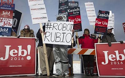 Aaron Black, wearing a robot suit in protest of Republican presidential candidate, Sen. Marco Rubio, R-Fla., stands outside a polling site at Bedford High School in Bedford, N.H., Tuesday, Feb. 9, 2016, as he awaits the senator's arrival (AP Photo/John Minchillo)