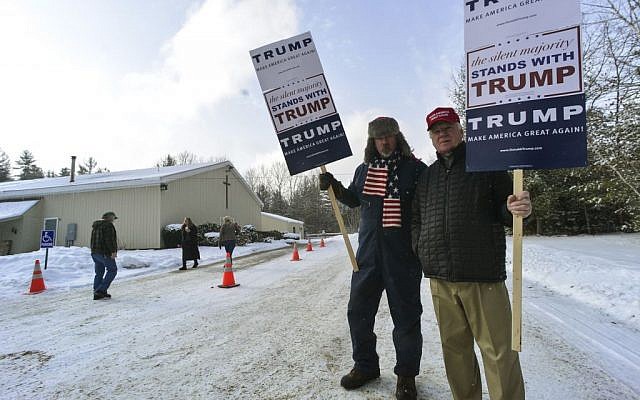 James Wall and H. Gregory Johnson, from Swanzey, N.H., hold signs of support for Republican presidential candidate Donald Trump outside the Swanzey, N.H. polling station during the New Hampshire primary on Tuesday, Feb. 9, 2016. (Kristopher Radder /The Brattleboro Reformer via AP)